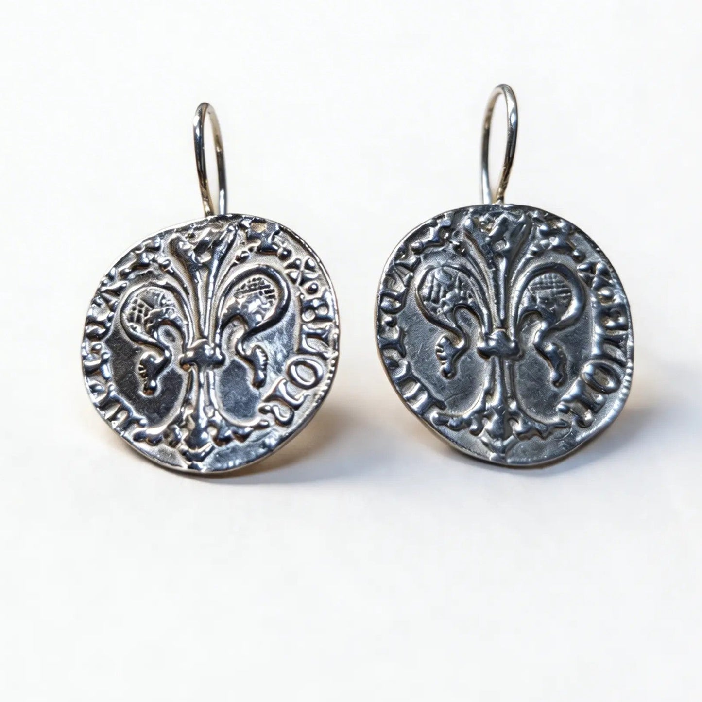 Florin coin earrings with a nun